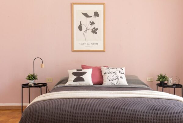 Camera da letto con parete rosa e letto, home staging per la vendita a Firenze